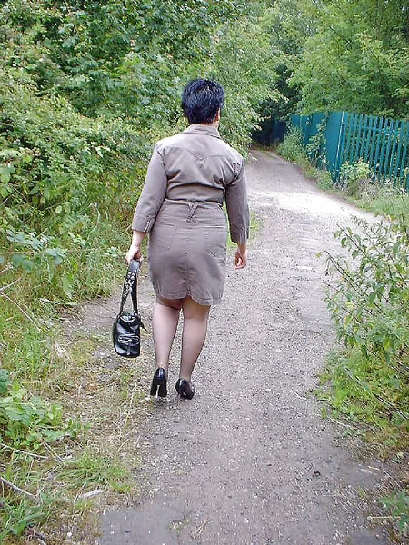 A mature German woman performs in the forest as an exhibitionist photo 12