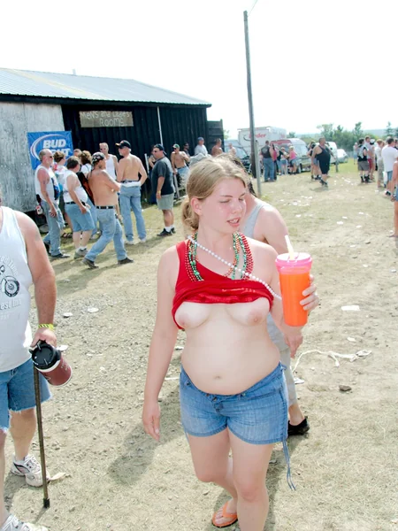Chubby women showing off their tits at a festival photo 8