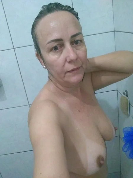 An older French woman masturbates after a shower
