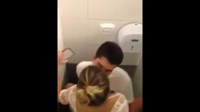 A guy films his friend having sex with a whore in the bathroom